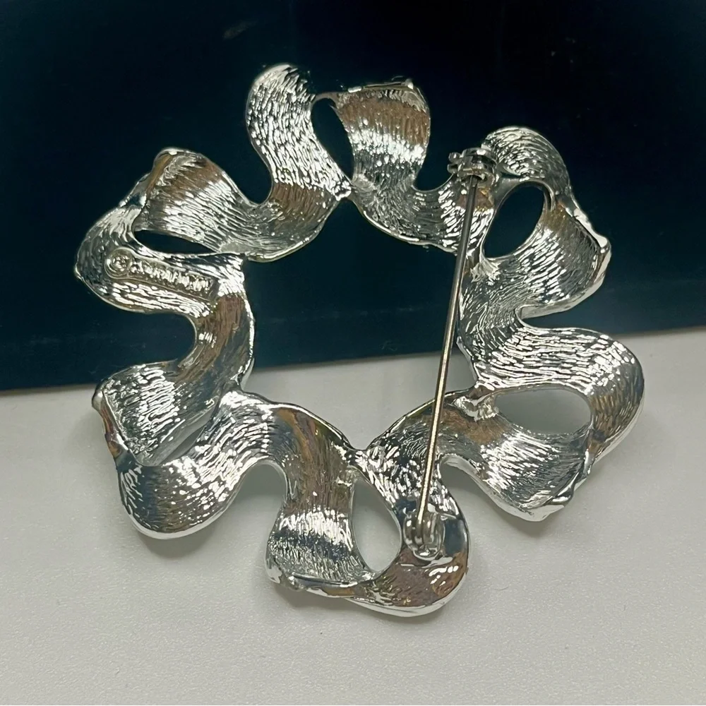 Two Elegant Silver tone Sarah Coventry brooches.